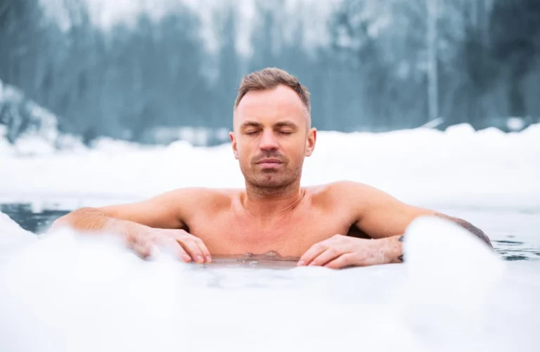 man in ice water to experience the cold plunge benefits
